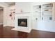 Living room featuring a cozy fireplace with white mantle and stylish built-in bookshelves at 622 Denali Dr, Mableton, GA 30126