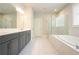 Spa-like main bathroom with double vanity, soaking tub, and a separate glass-enclosed shower at 622 Denali Dr, Mableton, GA 30126