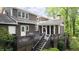 Exterior view showcasing the expansive deck, screened in porch, and mature landscaping at 3561 Stone Dr, Marietta, GA 30062