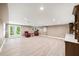 Spacious finished basement with modern flooring, natural light, wet bar, and comfortable seating area at 3561 Stone Dr, Marietta, GA 30062