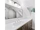 Bathroom featuring modern vanity with sleek countertops, decorative lighting, and large mirror at 3561 Stone Dr, Marietta, GA 30062
