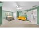 Bedroom with green walls, carpeted floors, a queen bed, and a yellow sofa at 3561 Stone Dr, Marietta, GA 30062