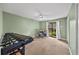 Comfortable bedroom with plush carpet, ceiling fan, natural light, and backyard view at 3561 Stone Dr, Marietta, GA 30062