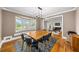 Formal dining room with a chandelier, large windows, and view into a living room with a piano at 3561 Stone Dr, Marietta, GA 30062