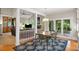 Open dining area features a dining table with seating, hardwood floors, and an adjacent Gathering room at 3561 Stone Dr, Marietta, GA 30062