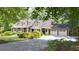 Charming home with a manicured lawn, a two-car garage, and lush landscaping at 3561 Stone Dr, Marietta, GA 30062