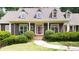 Inviting home with a spacious front porch, manicured shrubs, and a brick-lined walkway at 3561 Stone Dr, Marietta, GA 30062