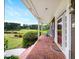 Covered brick front porch with comfortable seating and scenic views of the landscaped yard at 3561 Stone Dr, Marietta, GA 30062
