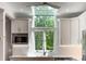 Bright kitchen with white cabinetry, stainless steel appliances, skylight, and a view of the green outdoors at 3561 Stone Dr, Marietta, GA 30062