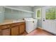 Bright laundry room features a sink, storage cabinets, modern washer and dryer, and access to the exterior at 3561 Stone Dr, Marietta, GA 30062