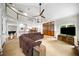 Open living space with second story balcony, media center, and decorative wood and glass paneled doors at 3561 Stone Dr, Marietta, GA 30062