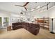 Open-concept living room with high ceilings, a ceiling fan, and views into a bright, modern kitchen at 3561 Stone Dr, Marietta, GA 30062
