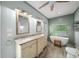 Bright main bathroom features dual vanities, a soaking tub with window, and a ceiling fan at 3561 Stone Dr, Marietta, GA 30062