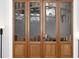 Close-up of the decorative wood and glass paneled doors with etched details at 3561 Stone Dr, Marietta, GA 30062