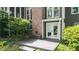 Open patio features a doorway to the home, brick chimney and lush greenery surrounding at 3561 Stone Dr, Marietta, GA 30062