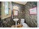 Charming powder room with unique floral wallpaper, pedestal sink, and decorative lighting at 3561 Stone Dr, Marietta, GA 30062