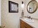 Elegant powder room with designer wallpaper, framed mirror, and modern vanity with updated fixtures at 3561 Stone Dr, Marietta, GA 30062