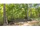 Photo displays a large wooden deck surrounded by trees with a walking path and stairway at 3561 Stone Dr, Marietta, GA 30062