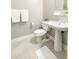 Clean, updated bathroom featuring a pedestal sink, toilet, and modern tile flooring at 4810 Ivy Ridge Se Dr # 303, Atlanta, GA 30339