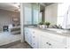 Bathroom featuring dual sinks, granite counters, white cabinets, and access to bedroom at 4810 Ivy Ridge Se Dr # 303, Atlanta, GA 30339