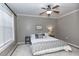 Bedroom showcasing a plush white rug, a ceiling fan, and a bright window with blinds at 4810 Ivy Ridge Se Dr # 303, Atlanta, GA 30339