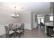 Bright dining room features a glass table, modern chandelier, and seamless flow to living spaces at 4810 Ivy Ridge Se Dr # 303, Atlanta, GA 30339