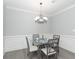 Dining room features a glass table, decorative chandelier, and paneled wainscoting at 4810 Ivy Ridge Se Dr # 303, Atlanta, GA 30339