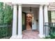 Grand entrance with white columns and a brick walkway leading to a decorative glass paneled door at 4810 Ivy Ridge Se Dr # 303, Atlanta, GA 30339