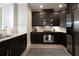 Modern kitchen with dark cabinets, granite countertops, and stainless steel appliances at 4810 Ivy Ridge Se Dr # 303, Atlanta, GA 30339