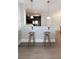 Kitchen bar features granite countertops, stylish pendant lighting, and modern stools at 4810 Ivy Ridge Se Dr # 303, Atlanta, GA 30339
