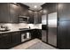 Updated kitchen with stainless steel appliances, dark cabinetry, and light granite countertops at 4810 Ivy Ridge Se Dr # 303, Atlanta, GA 30339