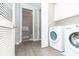 Bright laundry area with modern washer and dryer units adjacent to a half bath at 4810 Ivy Ridge Se Dr # 303, Atlanta, GA 30339