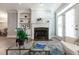 Bright living room with a fireplace, built-in shelving, and access to a patio through glass doors at 4810 Ivy Ridge Se Dr # 303, Atlanta, GA 30339
