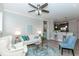 Bright living room with a ceiling fan, light grey walls, and an open view into the kitchen at 4810 Ivy Ridge Se Dr # 303, Atlanta, GA 30339