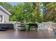 Relaxing deck with a hot tub, grill, and lounge seating, perfect for outdoor entertainment and relaxation at 681 Braidwood Nw Ter, Acworth, GA 30101