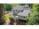 Aerial view of a private backyard deck with hot tub and wooded landscape, perfect for relaxation and entertaining at 681 Braidwood Nw Ter, Acworth, GA 30101
