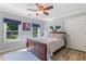 Cozy bedroom with a wooden sleigh bed, ceiling fan, and a lovely view of the outdoors at 681 Braidwood Nw Ter, Acworth, GA 30101