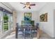 Bright dining room with light hardwood floors, blue dining set, and large window view at 681 Braidwood Nw Ter, Acworth, GA 30101
