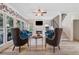 Inviting living room with floral wallpaper, fireplace, large windows and hardwood floors at 681 Braidwood Nw Ter, Acworth, GA 30101