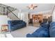 Spacious living room with hardwood floors, comfortable seating, and open view to the kitchen at 681 Braidwood Nw Ter, Acworth, GA 30101