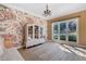 Floral wallpaper accentuates this living room, complete with a window and modern chandelier at 681 Braidwood Nw Ter, Acworth, GA 30101