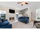 Cozy living room featuring a fireplace, staircase, modern light fixture, and comfortable seating at 681 Braidwood Nw Ter, Acworth, GA 30101