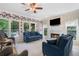 Well-lit living room with a fireplace, large windows, comfortable sofas, and hardwood floors at 681 Braidwood Nw Ter, Acworth, GA 30101