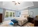 Tranquil main bedroom with tray ceiling, large windows, and neutral decor at 681 Braidwood Nw Ter, Acworth, GA 30101