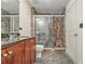 Bathroom featuring tiled walk-in shower, dark counter, and storage at 171 Auburn Ne Ave # 521, Atlanta, GA 30303