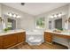 Spacious bathroom with separate vanities, garden tub, and wood-look flooring at 2109 Tranquility Ct, Woodstock, GA 30188