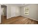 Neutral bedroom with wood floors and a window with a view of the front yard at 2109 Tranquility Ct, Woodstock, GA 30188