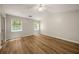 Bright bedroom featuring wood-look flooring, vaulted ceilings, and natural light from two windows at 2109 Tranquility Ct, Woodstock, GA 30188
