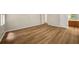 Spacious bedroom with wood floors, access to the kitchen, and plenty of natural light at 2109 Tranquility Ct, Woodstock, GA 30188