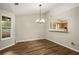 Cozy dining area with chandelier lighting and large window overlooking the yard at 2109 Tranquility Ct, Woodstock, GA 30188